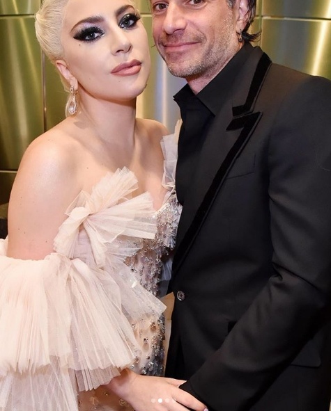 Backstage at the Grammys, Lady Gaga in Armani Prive kisses her boyfriend, talent commercial agent Christian Carino 2