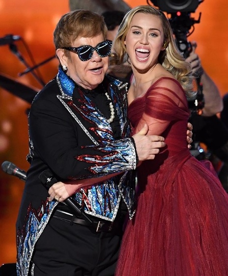 Miley Cyrus belts out Tiny Dancer alongside Elton John at the Grammys.